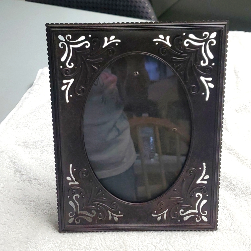 Fetco brown metal frame.  Picture 6-1/2" long, 4-1/2" wide.